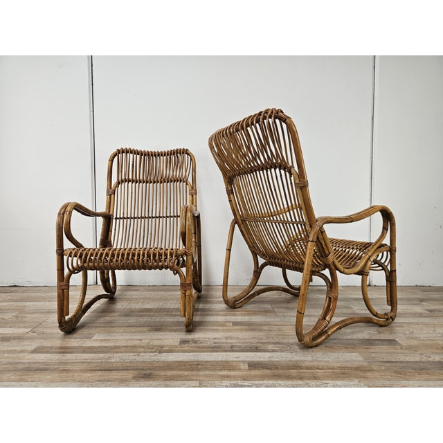 Pair of vintage 1970s wicker and bamboo armchairs. Ideal for decorating an outdoor space, a porch, or an entryway. They...