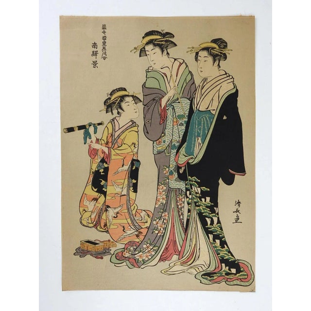 Vintage mid 20th century Japanese woodblock reprint of a courtesans admiring a telescope by Torii Kiyonaga. A Scene of the...