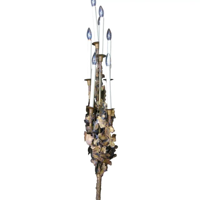 This Tom Greene Style Brutalist Brass Torchère features a series of multi-level candles and sculpted torch-cut accents....