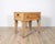 This elegant Louis XVI–style table is crafted in light-toned wood and features refined neoclassical proportions. The piece...