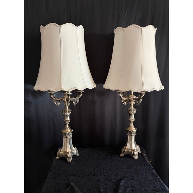 An exquisite pair of French Louis XVI–style four‑arm candelabra lamps, crafted with exceptional detail and refined...