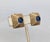 Late 1940s square goldtone ribbed raised center with cabochon faux-sapphire in the middle clip earrings. Marked "MAZER" on...