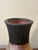 A hand-thrown American studio ceramic vase from the mid-century period. The body features a marbled clay composition in...