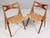 Hans J. Wegner sawbuk dining chairs in oak frame and teak back. Seat upholstered with patinated full grain nature aniline...
