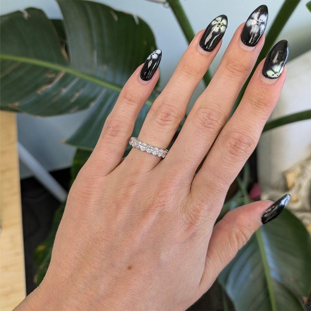 Twenty oval lab grown diamonds totalling 2.66 carats sparkle in a continuous line across this solid 14K white gold band....
