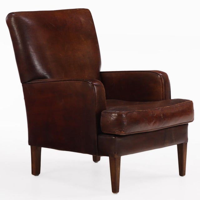 This warm brown tone chair is in very good condition and sits well with squared crest and arms and subtly canted back. It...