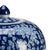 Hand painted blue ceramic with a removable lid and decorated with a white flower pattern.