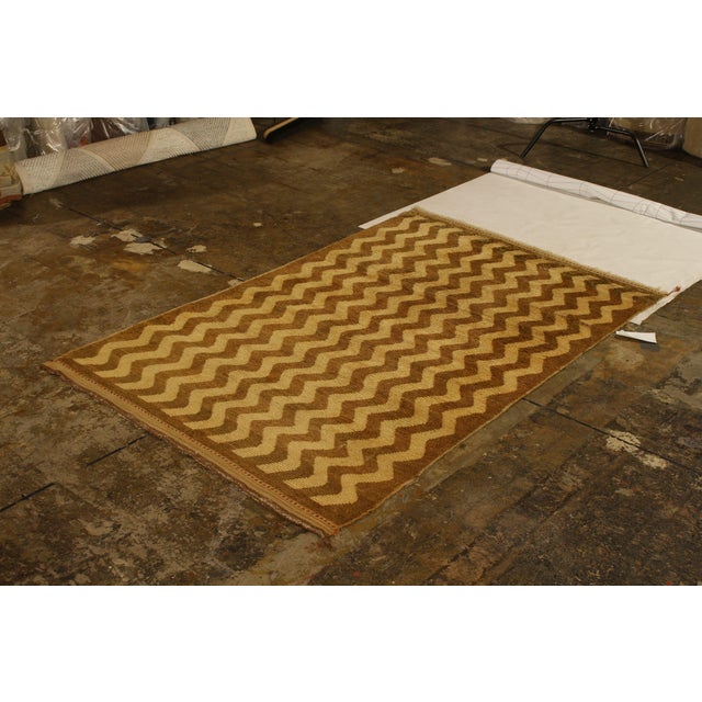 Hand knotted in wool originating from Turkey circa 1950-1960, this vintage rug connotes a mid-century Tulu rug design,...