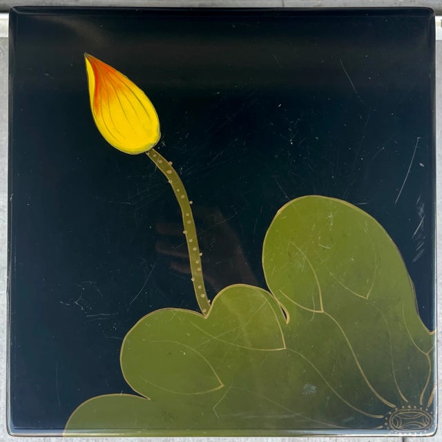 Asian lacquered pedestal with lily pad motif. Bold color palette with black, green yellow and orange.