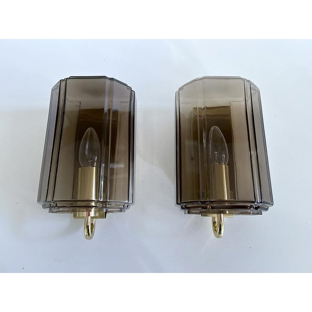 Pair of Vintage Limburg wall Lights featuring smoked glass shades mounted on a brass rectangular frame, original 1970s...