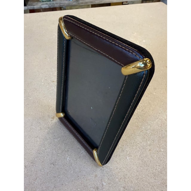 Refined Italian picture frame from the 1970s, crafted in dark green leather with contrasting brown leather trim and...