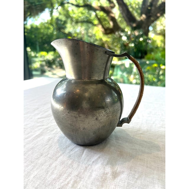 Beautifully made pewter pitcher by Just Andersen, Denmark, with a woven handle. Original vintage patina of the pewter and...
