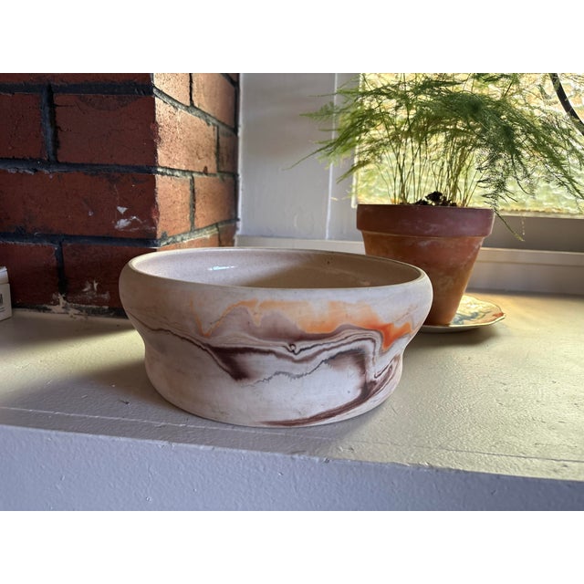 Handcrafted vintage Nemadji pottery bowl featuring the maker’s signature marbled clay decoration in warm cream,...