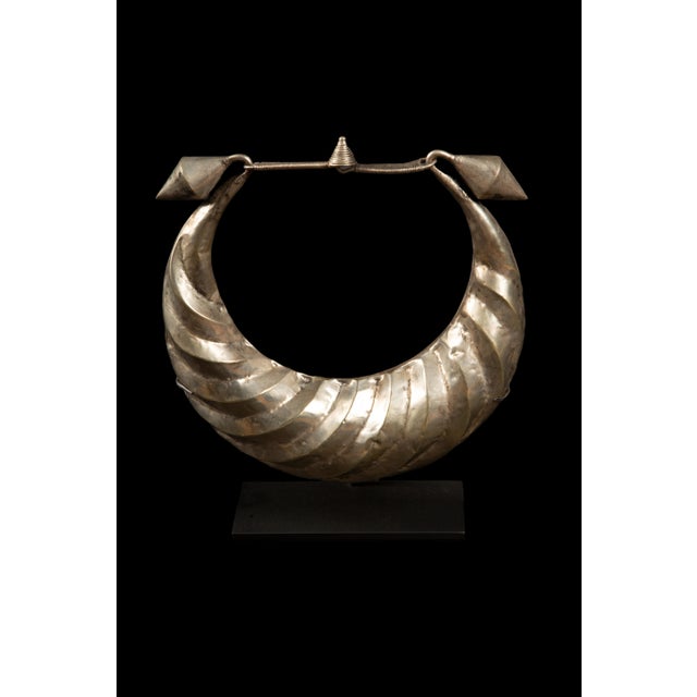 Stunning Silver Miao Minority Tribe Necklace mounted on a custom base. Meticulously designed to add a touch of cultural...