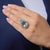 This striking Art Deco inspired cocktail ring centers on a breathtaking 10.17 carat Portuguese cut pear shape aquamarine,...
