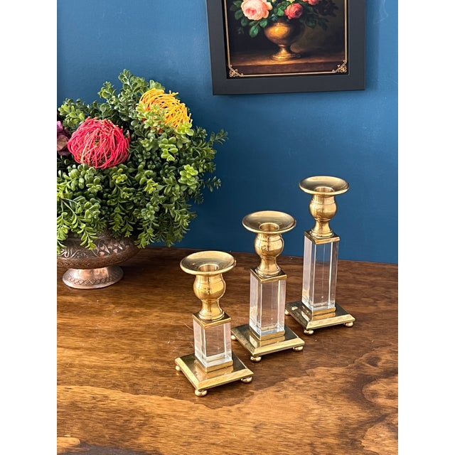 Vintage brass and lucite candlestick holders set of three featuring elegant mid century modern design with clear lucite...