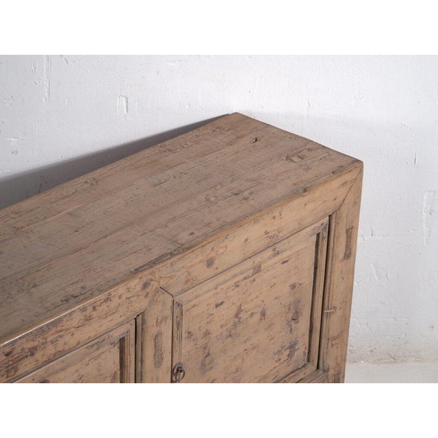 Antique Chinese sideboard in solid elm, originally from Shanxi and dated toward 1920. A large-scale functional storage and...
