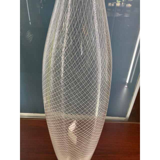 This is a tall, elegant, exquisite hand-blown vase, signed (engraved) and dated at the bottom, created by the now-famous...