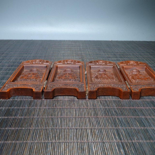 An exquisite and highly detailed vintage Chinese four-panel miniature folding screen, masterfully carved from solid...