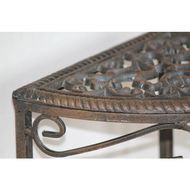 This plant stand is made to stand in the corner! A cast iron filigree-style, scrolled top that is welded to wrought iron...