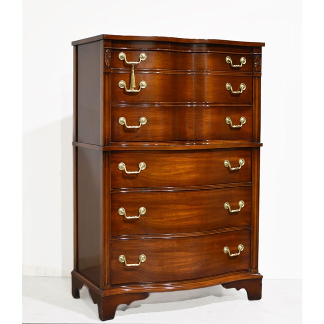 This mid century Georgian serpentine chest-on-chest is crafted from rich mahogany veneer with a warm, high-gloss finish...