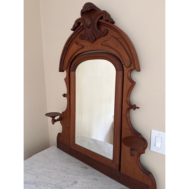 Beautiful antique Victorian marble-top dresser featuring an ornate carved mirror, original marble top, and three spacious...