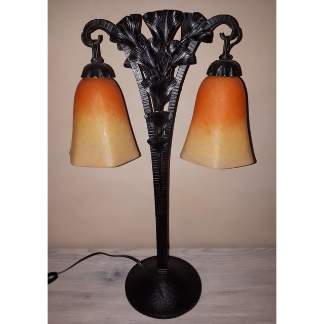 Art Deco wrought iron lamp decorated with ginkgo biloba leaves, with two light sources. The bulb covers are signed...