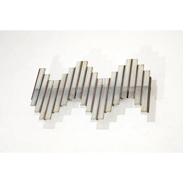 A rare and impressively sculptural Brutalist wall lamp, a vintage Italian design piece dating back to the 1970s. This...