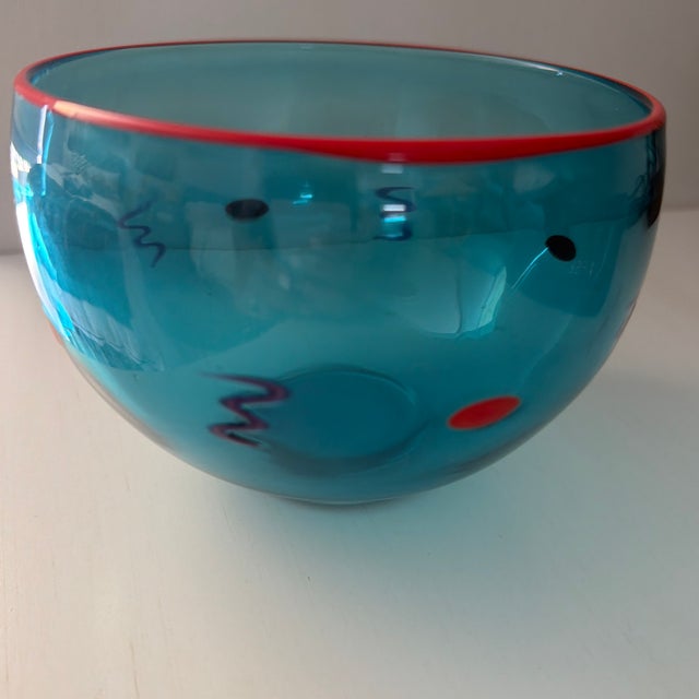 This hand-blown Murano-style studio art glass bowl in the most beautiful Mediterranean blue features a bright red rim. Red...