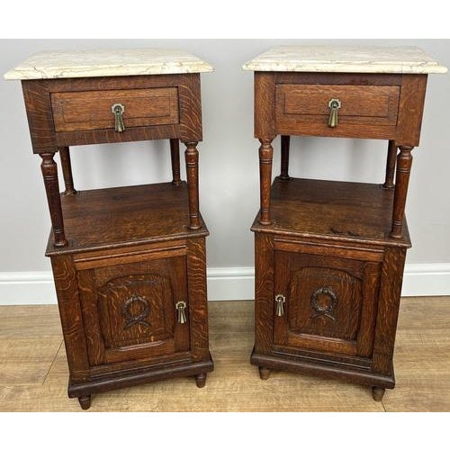 A refined pair of Antique French bedside tables featuring elegant marble tops and beautifully aged oak, offering timeless...