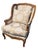 This is a stunning French Provincial, Louis XV–style wingback bergère chair with a hand-carved walnut frame finished with...