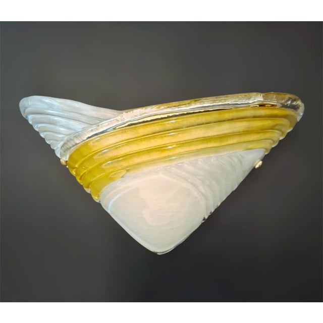 Vintage pair of Italian wall lights with frosted white Murano glass shades and amber ribbed band / Made in Italy in the...