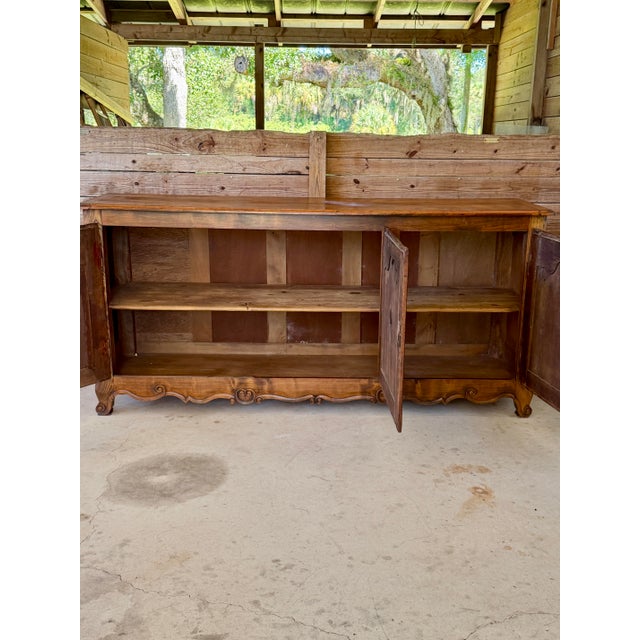 A substantial late 19th-century French Provincial three-door enfilade or buffet, dating to approximately 1880–1900....