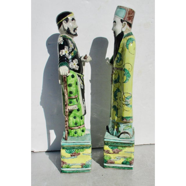 Kangxi porcelain figures of two immortals, known as Li Tieguai, with the cane, and Fu Xing, good fortune. Sancai-glazed...