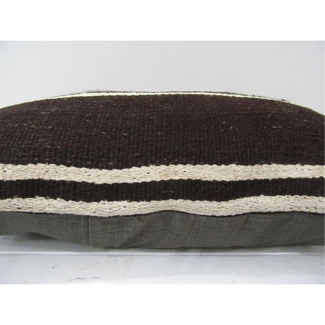 This is a pillow cover made from a vintage kilim rug. The piece was properly washed and ready to use. Pillow inserts not...