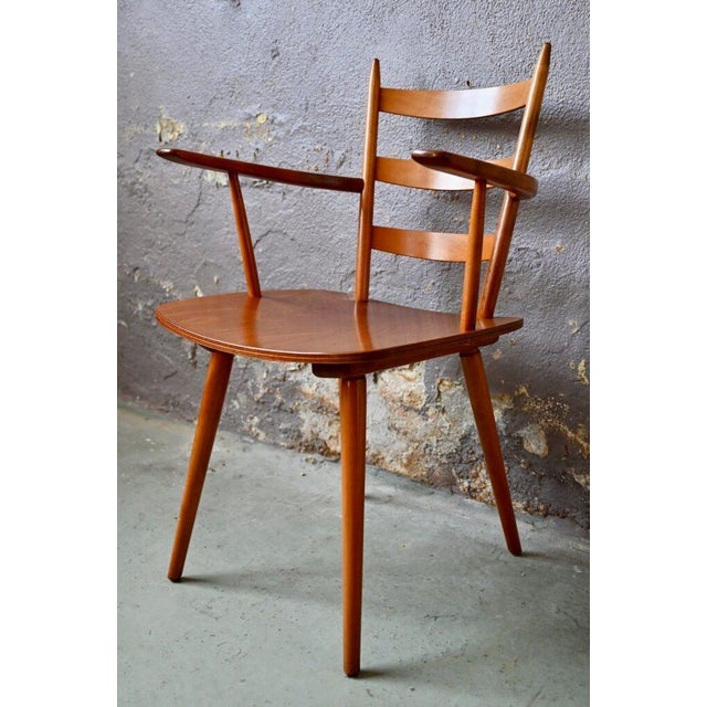 These lovely armchairs, made of beech and plywood in a light honey shade, feature sleek, purposeful lines in a...