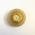 A circular vintage compass paperweight. Features a central compass with brass trim, set in a circular piece of onyx. Taupe...