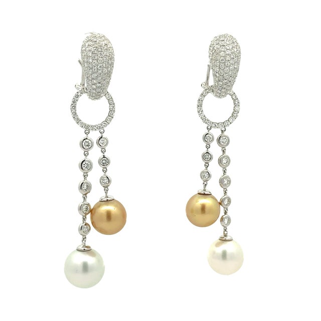 Crafted in 18k white gold, these earrings are a striking addition to any collection, featuring 11mm of golden and white...