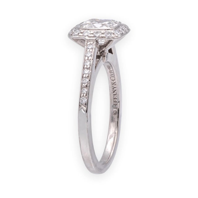A Tiffany & Co. Legacy engagement ring crafted in platinum (Pt950), set with a 0.98 carat cushion-cut center diamond...