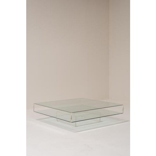 Minimalist coffee table from the 1970s combining glass and acrylic glass in a clean, architectural design. The table...