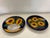 Vintage pair of Mexican earthenware wall plates with sunflower motif. Brightly painted in indigo, brown, and goldenrod....