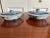 A pair of chinese export style canton blue and white covered dishes. Melon finials with landscape decoration to each