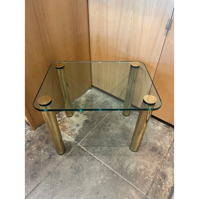 Fantastic 80's Pace Collection Glass Top Side Table with Brass Legs. This table features a considerable piece of glass...