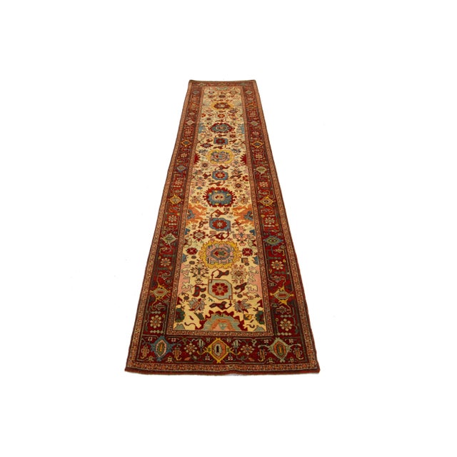 This beautiful modern Oushak hand-knotted wool rug features a beige color field. It is a Turkish piece with a red frame...