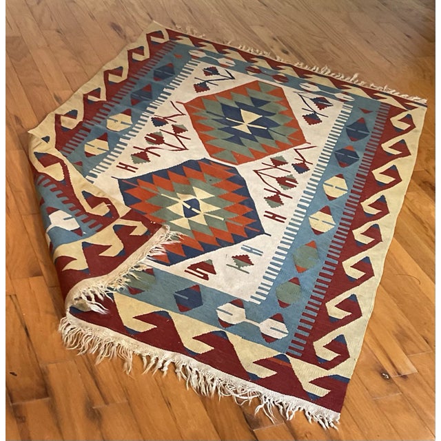 Vintage hand-woven Kilim wool rug in a dynamic pattern in a colorful, multicolored bold scheme. Pin it up on a wall in...