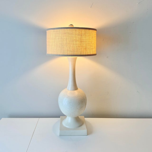 Vintage mid-century modern floral embossed ceramic table lamp with short barrel shade.