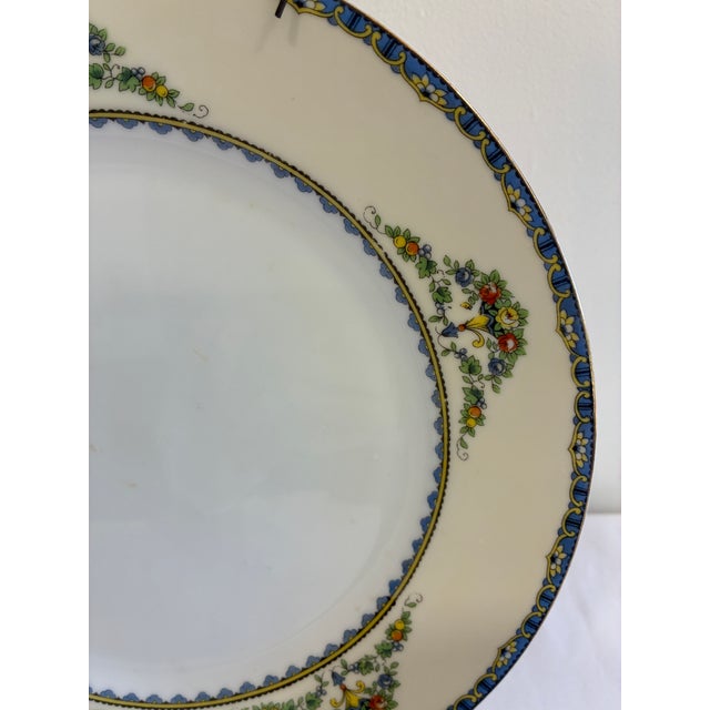 An elegant vintage Noritake dinner plate in the Avril pattern, made in Japan. The design features delicate floral garlands...