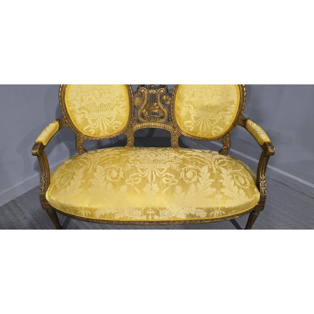 A very nice French two seat gilded and carved couch, recently upholstered in Italian silk fabric, in overall very good...