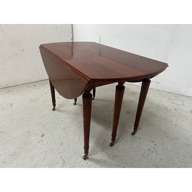 Louis xvi style mahogany drop-leaf table four tapered legs with bronze rings three mahogany veneer extensions, each 45cm...