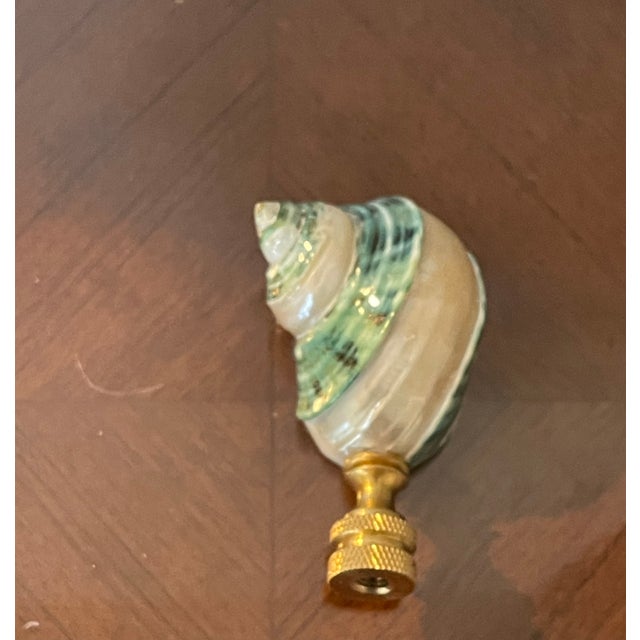 Natures beauty polished in stripes blue mother of pearl turbo sea shell mounted on a brass base lamp finial.